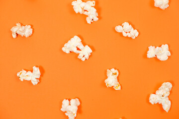 Popcorn on an orange background, close-up view from above