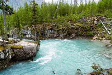 Teal water of the Kootenay River rushes through Marble Canyon in Kootenay National Park, British Columbia