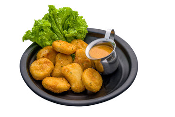 Nuggets with nanyang curry served in a dish isolated on white background side view