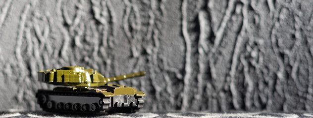 Green Plastic Tank Toy on dark background