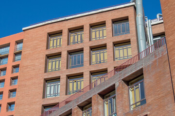 Fototapeta na wymiar brick facade building with rectangular windows in Madrid. Spain