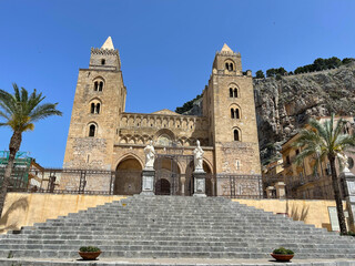 Fototapeta na wymiar Duomo Cefalu, Sicily exterior with grand staircase and rocky mountain in background