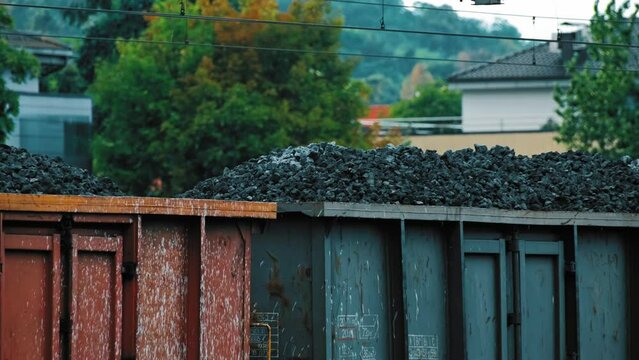 Long Haul Cargo Freight Train with Bituminous Black Coal Waiting at Railway Siding 