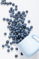 Blueberries on white background. Juicy fresh blueberry on table. Flat lay, top view, copy space