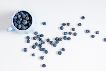 Blueberries on white background. Juicy fresh blueberry on table. Flat lay, top view, copy space