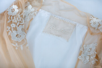 Fototapeta premium Beige wedding dress with lace. Details closeup