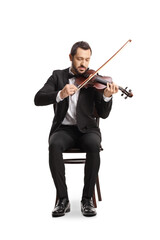 Full length portrait of an elegant young man sitting and playing a violin