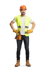 Full length portrait of a site engineer wearing a tool belt and smiling at camera