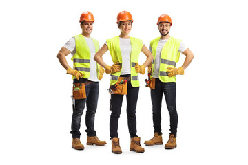 Full length portrait of site engineers wearing a tool belt and safety vests