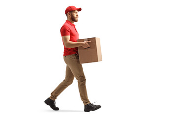 Full length profile shot of a courier carrying a cardboard box and walking