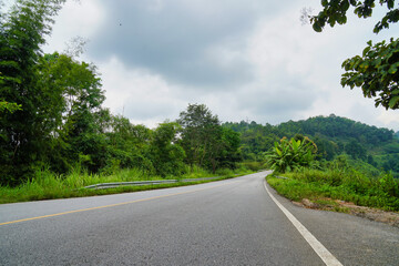 Fototapeta na wymiar A long road in a valley area in Thailand