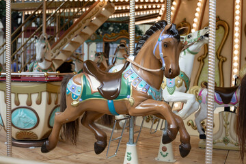 Fototapeta na wymiar Brown horse in the carousel, flare park family vacation, toy horse