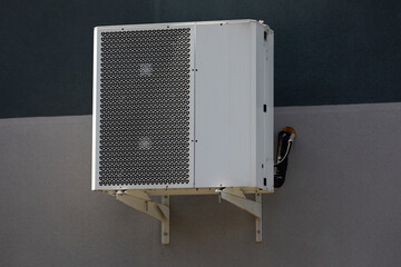 cooling unit for duct air conditioner hanging on the wall of the building