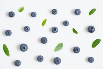 Blueberry pattern on white background. Bilberry berries with green leaves. Top view.