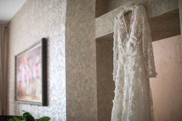Wedding dress hanging on the door arch