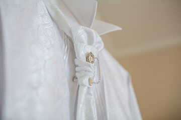 White wedding shirt with decorations. Details closeup