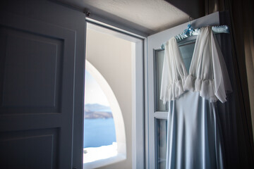 Fototapeta na wymiar Blue wedding dress hanging on the door
