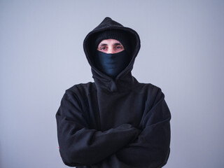 Unrecognizable thief in black hoodie and sweatshirt. Security concept