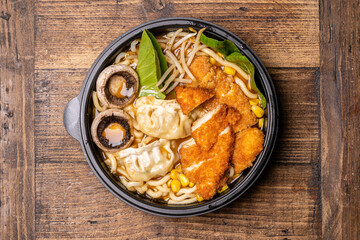  Sushi black plate on wood table, top view.