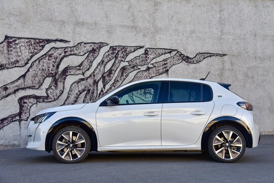 Peugeot e-208 GT Line. An attractive small electric car with a good range. General side view. 04-30-2022, Prague, Czech Republic.