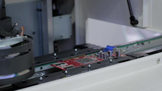 Automated visual optical inspection system for quality control of printed circuit board - close up view. Measurement, industrial, robotic, production, technology and manufacturing concept
