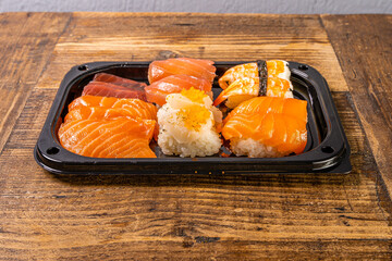 Sushi black plate on wood table,