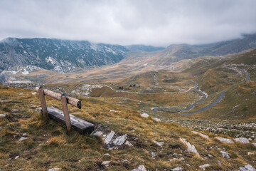 Empty bench watching over a mountain range in Durmitor national park, Montenegro