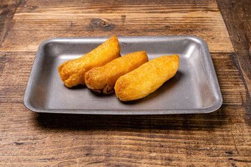 Sushi steel plate on wood table.