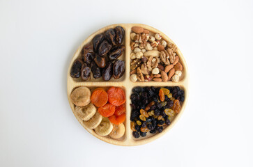 combined plate with dried fruits and nuts. in each compartment of the plate there is food