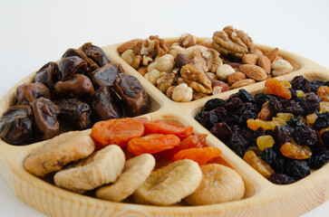 combined plate with dried fruits and nuts. in each compartment of the plate there is food