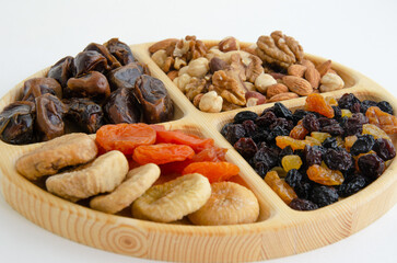 combined plate with dried fruits and nuts. in each compartment of the plate there is food