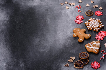 Christmas homemade gingerbread cookies on a dark concrete table