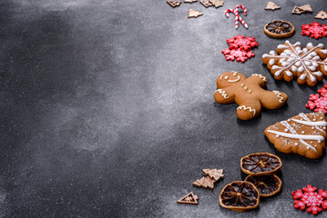 Christmas homemade gingerbread cookies on a dark concrete table