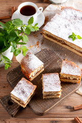 Clasic sponge cake with apples on table, selective focus. Homemade cake