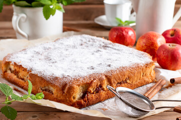 Clasic sponge cake with apples on table, selective focus. Homemade cake