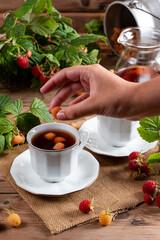Raspberry tea with natural berries on wooden table, vitamin tea for weight loss