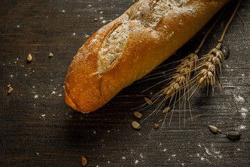 Fresh bread baguette loaf with seeds in a rustic style. Baking homemade healthy bread