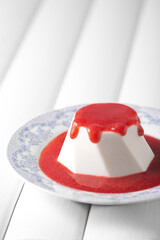 Strawberry souffle on a white plate, food photography. Panna Cotta