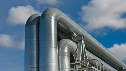 pipeline, in the photo pipeline close-up against a background of green forest and blue sky.