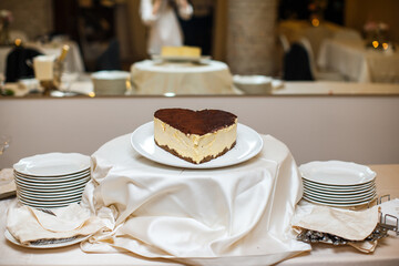 Wedding cake on the table with cream and chocolate