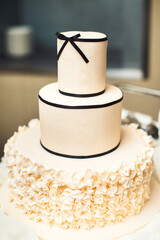 Multilevel wedding cake decorated with black ribbons