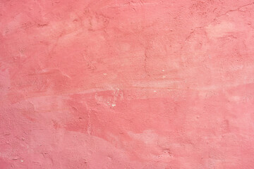 Fototapeta premium Old cement wall painted pink with peeling paint