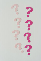 eight paper question marks on blank paper