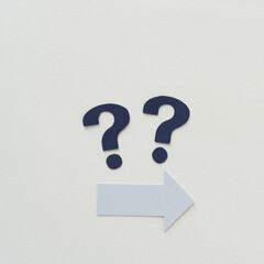 paper arrows and question marks