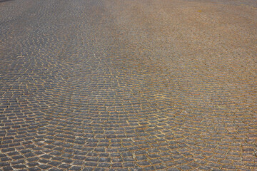 Close up view of texture of paving slabs paved pavement with old cobblestones. Sweden.