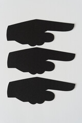 three pictographic glyphs (hand with pointing finger) on blank paper