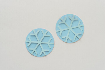 two paper snowflakes on circles 