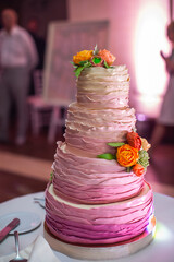 Obraz na płótnie Canvas Multilevel wedding cake decorated with edible flowers
