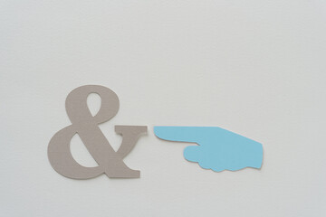 blue paper manicule or typographic mark (hand with extended index finger pointing) and gray paper...
