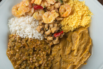 Caruru. Traditional Afro-Brazilian dish made with okra and dried shrimp, accompanied by vatapa, beans, rice, shrimp and farofa.